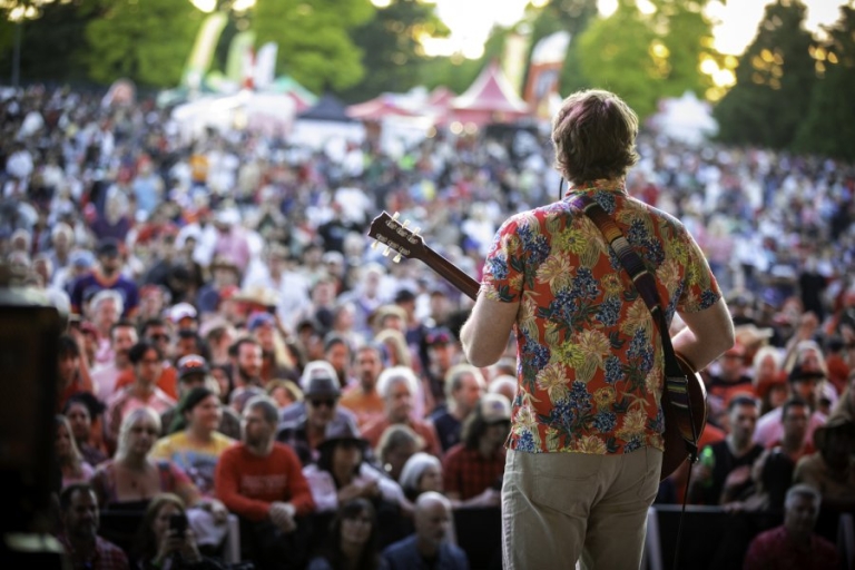 Artist playing to a crowd of people at Surrey Canada Day